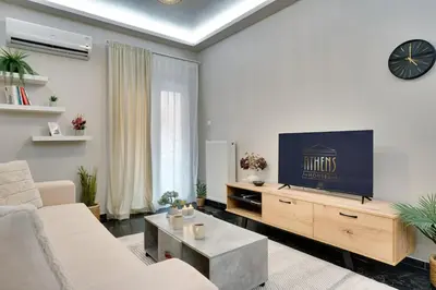 a living room with a couch and a tv at Lovely Goudi Apartment - Perfect Athens Getaway in Athens