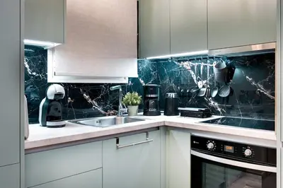 a kitchen with white cabinets and a sink at Lovely Goudi Apartment - Perfect Athens Getaway in Athens