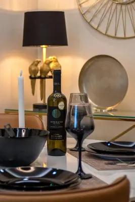 a bottle of wine and a glass on a table at Acropolis view luxury apartment in Athens