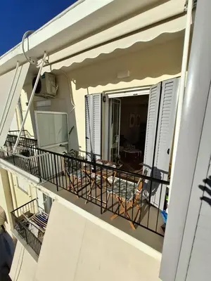 a balcony on a condo with a view of the living room at Acropolis view luxury apartment in Athens