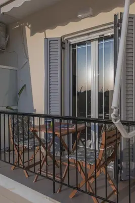 a balcony with a table and chairs at Acropolis view luxury apartment in Athens