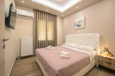 a bedroom with a bed with two towels on it at Acropolis view luxury apartment in Athens