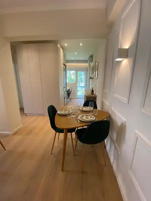 a kitchen and dining room with a table and chairs at Chic Athenian Apartment by the Riviera in Athens
