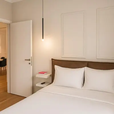 a bedroom with a white bed with white pillows at Chic Athenian Apartment by the Riviera in Athens
