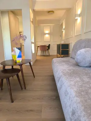 a bedroom with a bed and a table with a bowl on it at Chic Athenian Apartment by the Riviera in Athens