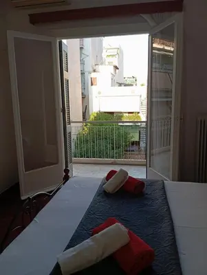 a bedroom with a bed with two towels on it at Quiet private room in a dormitory 5' from metro in Athens