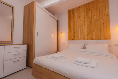 a bedroom with a white bed with two towels on it at Calmio Athens 4 in Athens