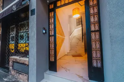 an entrance to a building with a door and stairs at Calmio Athens 4 in Athens