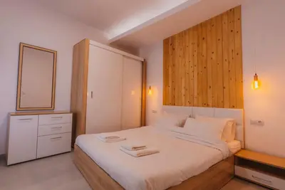 a bedroom with a bed with a mirror and a cabinet at Calmio Athens 4 in Athens