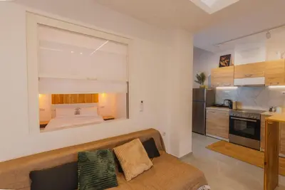a living room with a couch and a bed at Calmio Athens 4 in Athens