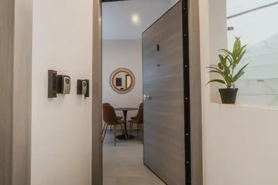 a door leading into a room with a table at Calmio Athens 4 in Athens