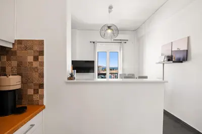 a kitchen with white walls and a white counter top at Luxury 2BR Penthouse Marina & Sea Views in Piraeus