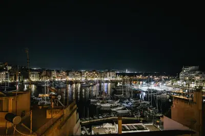 a harbor at night with boats in the water at Luxury 2BR Penthouse Marina & Sea Views in Piraeus
