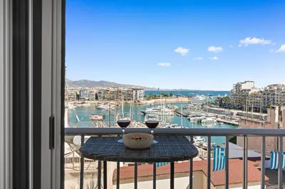 a balcony with a table with two glasses of wine at Luxury 2BR Penthouse Marina & Sea Views in Piraeus