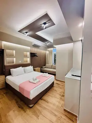 a bedroom with a large bed and a couch at Monastiraki 110 SuperHost Hub in Athens