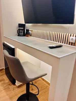 a desk with a chair and a television on it at Monastiraki 110 SuperHost Hub in Athens