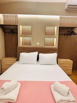 a bedroom with a large bed with two towels on it at Monastiraki 110 SuperHost Hub in Athens