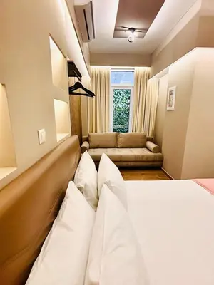 a hotel room with a bed and a couch at Monastiraki 110 SuperHost Hub in Athens