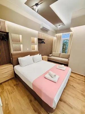 a bedroom with a large bed with two towels on it at Monastiraki 110 SuperHost Hub in Athens
