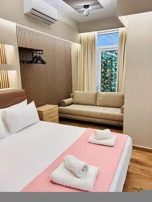 a bedroom with a large white bed with two towels at Monastiraki 110 SuperHost Hub in Athens