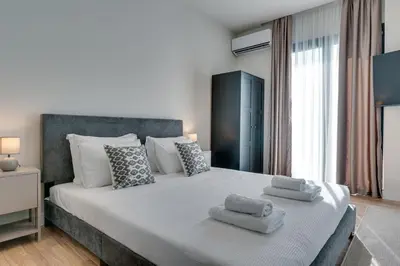 a bedroom with a large bed with towels on it at Skyline Spa Athens 130 A in Athens