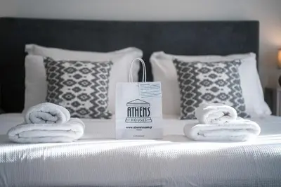 a bed with three towels and a bag of nutrients energy at Skyline Spa Athens 130 A in Athens