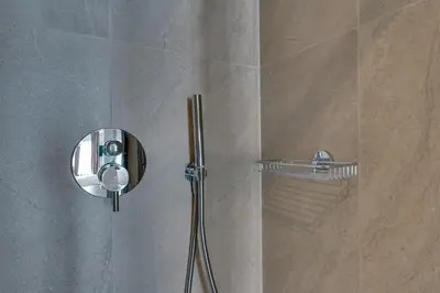 a shower in a bathroom with a glass door at Skyline Spa Athens 130 A in Athens