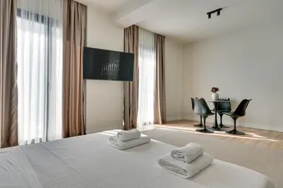 a bedroom with a bed with two towels on it at Skyline Spa Athens 130 A in Athens
