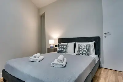 a bedroom with a large bed with towels on it at Skyline Spa Athens 001 in Athens