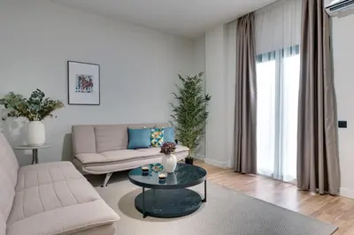 a living room with a couch and a table at Skyline Spa Athens 001 in Athens