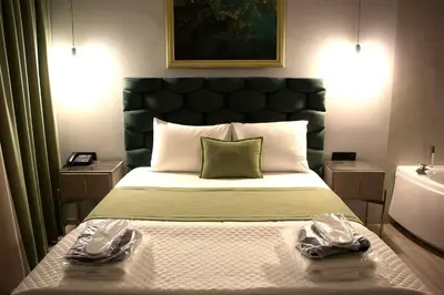 a bedroom with a bed with two pairs of shoes on it at VIP Suite 107 - Castle De Paris in Athens