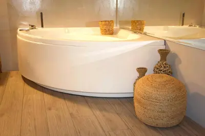 a bathroom with a tub and a sink and two vases at VIP Suite 107 - Castle De Paris in Athens