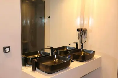 a bathroom with three bronze sinks in front of a mirror at VIP Suite 107 - Castle De Paris in Athens