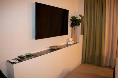 a flat screen tv on a wall in a room at VIP Suite 107 - Castle De Paris in Athens