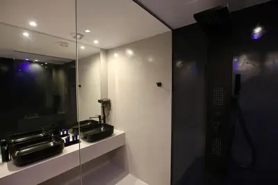 a bathroom with two sinks and a mirror at VIP Suite 107 - Castle De Paris in Athens