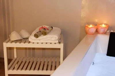 a baby crib with a towel and two candles at VIP Suite 108 - Castle De Paris in Athens