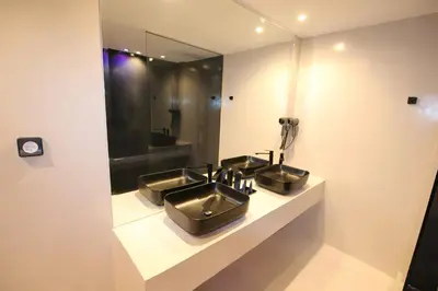 a bathroom with three sinks and a mirror at VIP Suite 108 - Castle De Paris in Athens