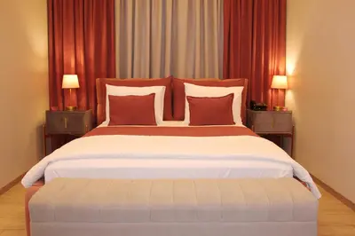 a bedroom with a large bed with two night stands at VIP Suite 108 - Castle De Paris in Athens