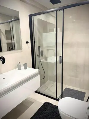 a bathroom with a shower and a toilet and a sink at EazyRent Apartments Athens Comfort-Work Stay-Free Parking in Athens