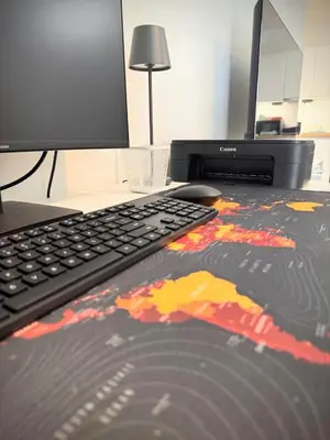 a computer keyboard and a computer monitor on a desk at EazyRent Apartments Athens Comfort-Work Stay-Free Parking in Athens