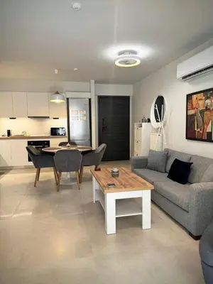 a living room with a couch and a table at EazyRent Apartments Athens Comfort-Work Stay-Free Parking in Athens