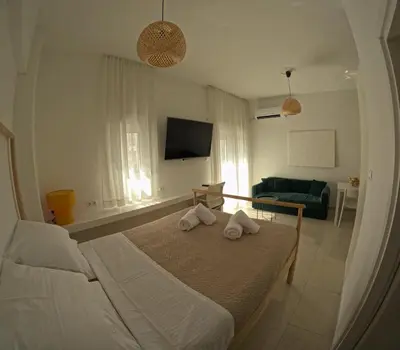 a bedroom with a bed with two towels on it at Little Big Athens in Athens