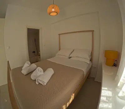 a bedroom with a bed with towels on it at Little Big Athens in Athens