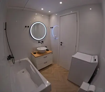 a white bathroom with a tub and a sink at Little Big Athens in Athens