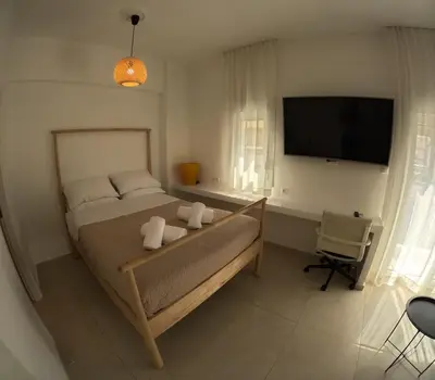 a bedroom with a bed and a flat screen tv at Little Big Athens in Athens