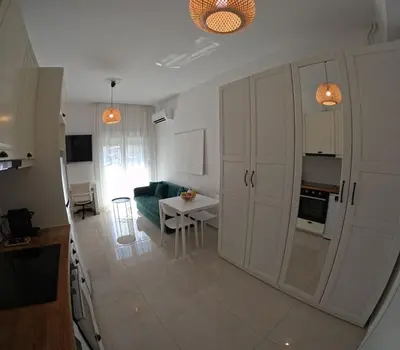 a kitchen and living room with a table and a couch at Little Big Athens in Athens