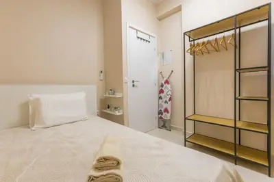 a bedroom with a bed and a closet at Saronic retreat Varkiza in Vari