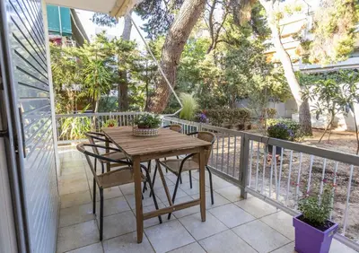 a wooden table and chairs on a balcony at Saronic retreat Varkiza in Vari
