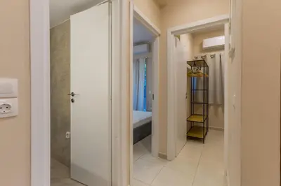 a bathroom with a walk in shower next to a tub at Saronic retreat Varkiza in Vari