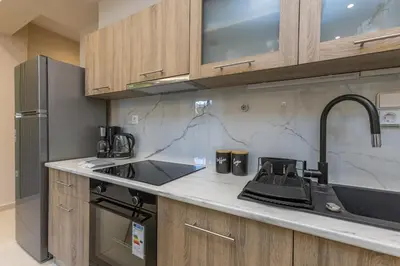 a kitchen with a sink and a counter top at Saronic retreat Varkiza in Vari